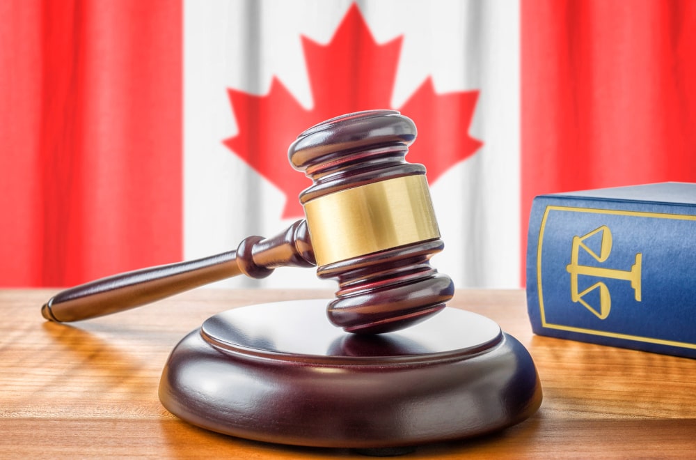 Canadian law gavel and law book representing legal cases and penalties for CSAE material