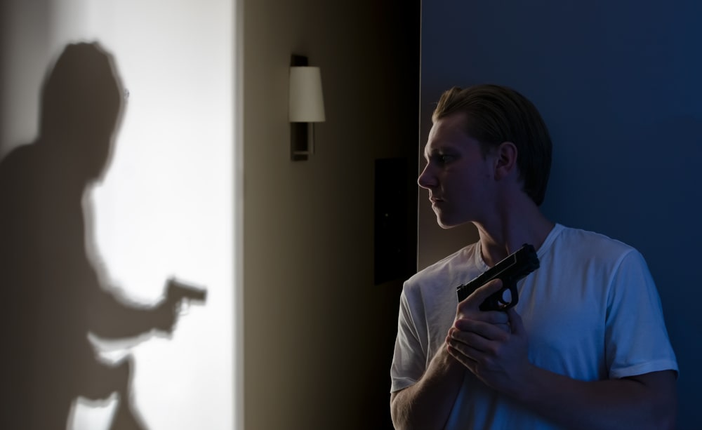 Person breaking into a home representing self-defence situations in Canada