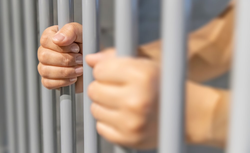 Least, Average and Maximum Sentences in Sexual Assault Cases: A person behind bars in a jail cell incarcerated